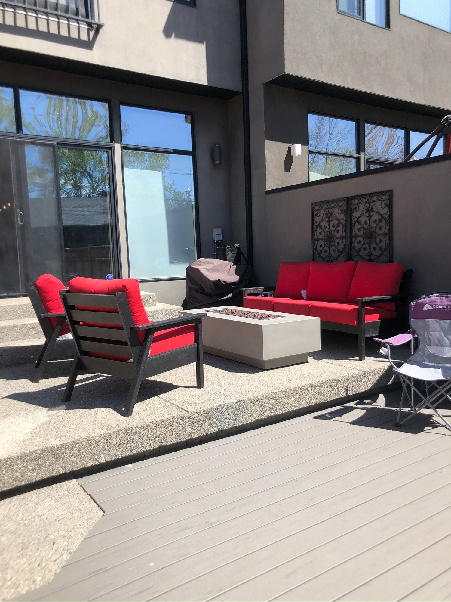 Thick concrete linear fire table with sleek straight sides and a long rectangular flame in the middle. This fire table has wide edges for glassware and fits perfectly on a deck or tight space. Available at Barbecues Galore: Burlington, Oakville, Etobicoke & Calgary