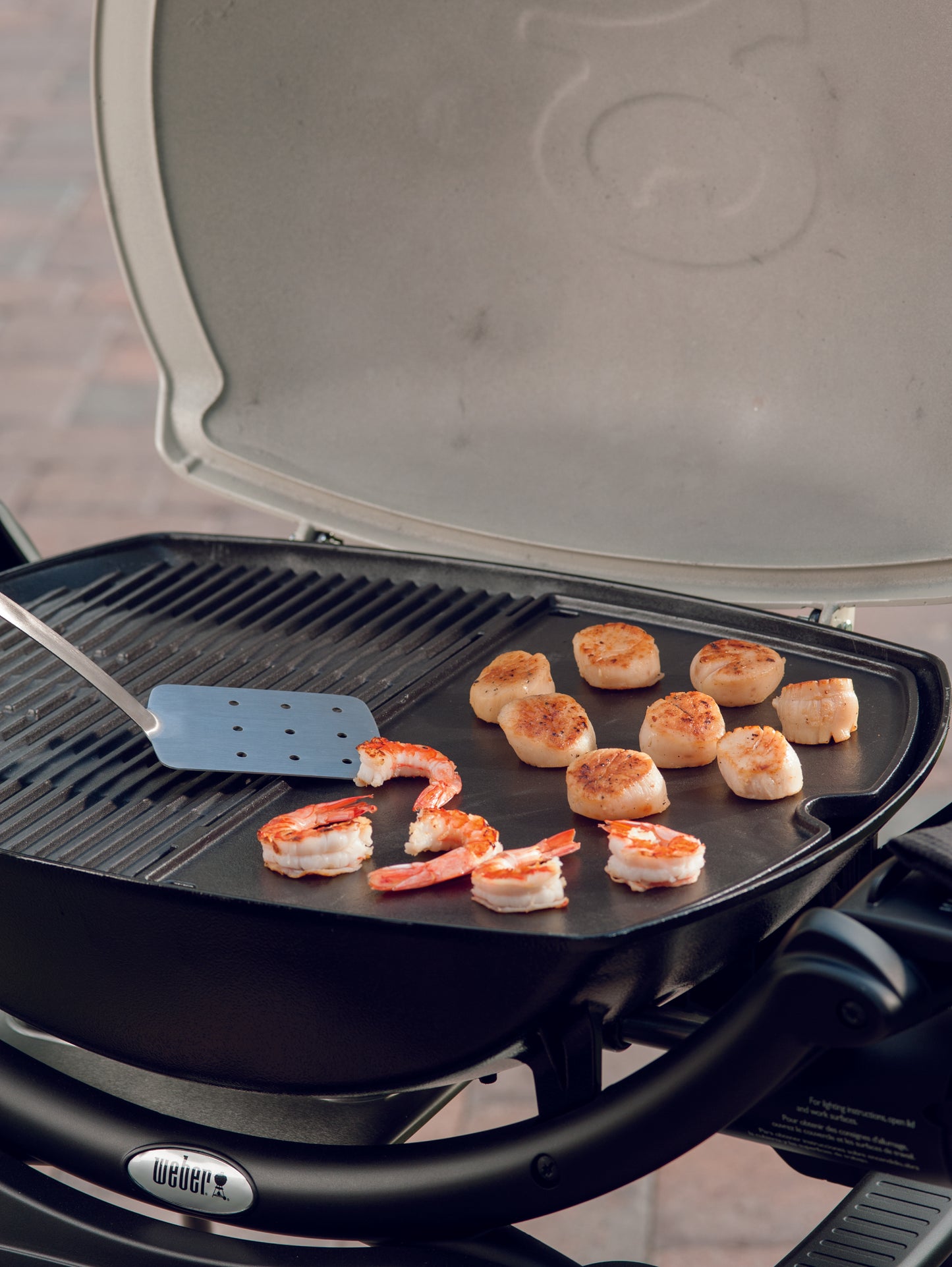Weber 6559 Cast Iron Griddle | Available in-store and online with Barbecues Galore. 3 Locations in the GTA: Burlington, Oakville & Etobicoke, Ontario. 2 Locations in Calgary, Alberta. We have all of your Bbq, patio, parts and accessory needs!