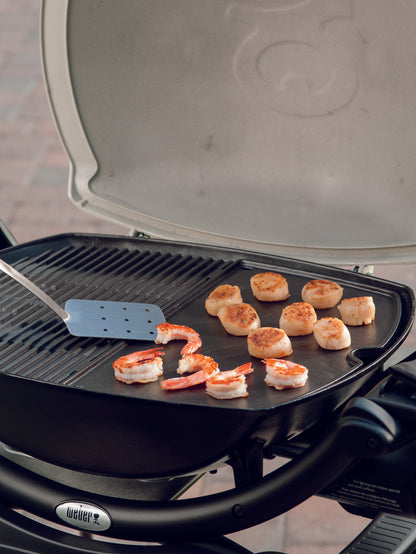 Weber 6559 Cast Iron Griddle | Available in-store and online with Barbecues Galore. 3 Locations in the GTA: Burlington, Oakville & Etobicoke, Ontario. 2 Locations in Calgary, Alberta. We have all of your Bbq, patio, parts and accessory needs!